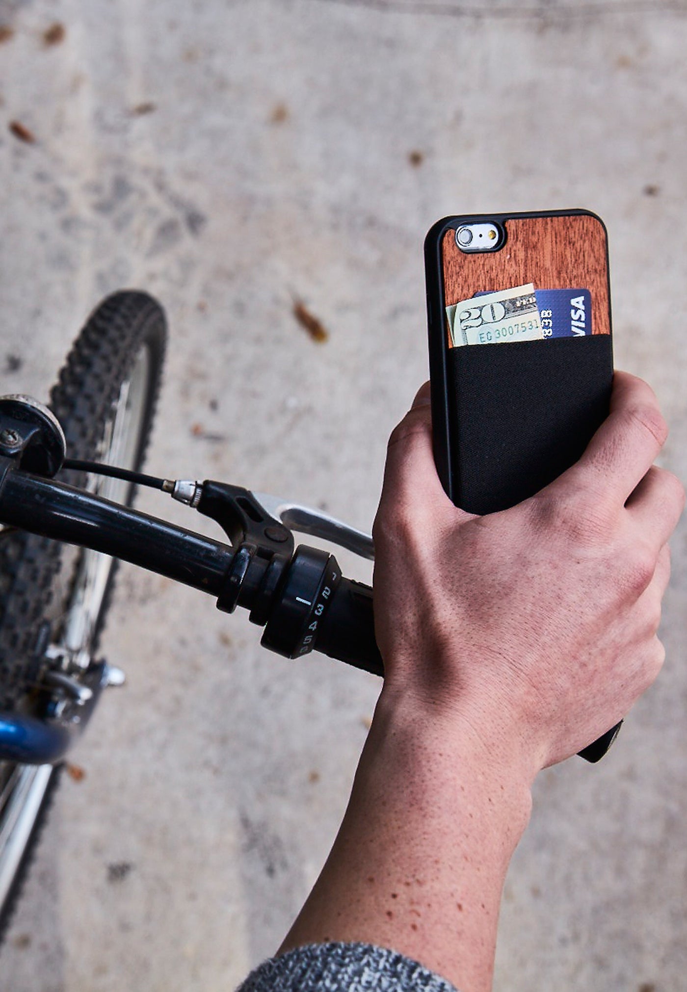 Man on bike holding a jimmycase